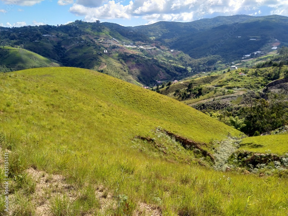 Naklejka premium Mountain landscape with green meadows and blue sky in Venezuela