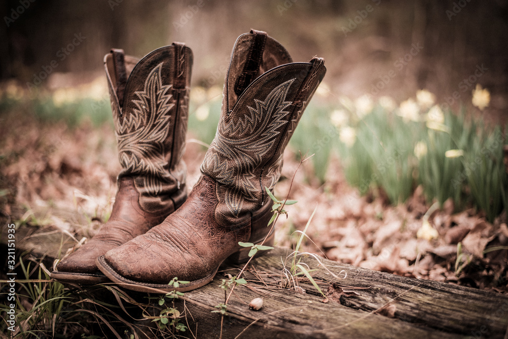 Worn western style cowboy boots out on old fence post Stock Photo | Adobe  Stock