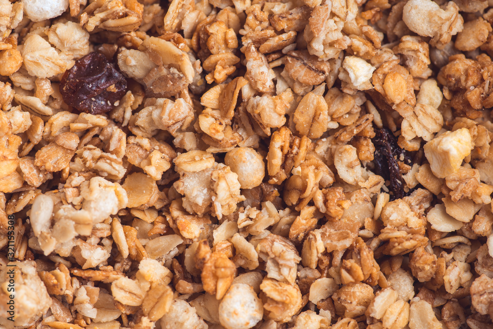 Useful and tasty muesli with nuts, rasins and flakes. Selective focus macro shot with very shallow depth of field. Healthy and vegetarian lifestyle Useful and tasty muesli with nuts, rasins and flakes. Selective focus macro shot with very shallow depth of field. Healthy and vegetarian lifestyle
