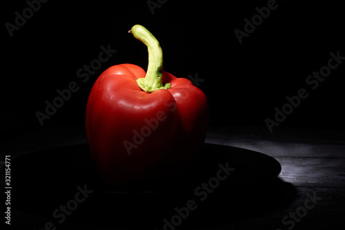 red sweet pepper on a black background