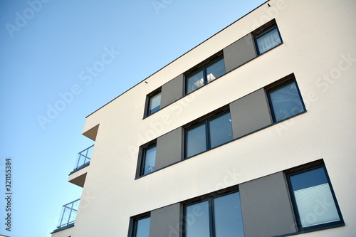 Contemporary residential building exterior in the daylight. Modern and new apartment building. 