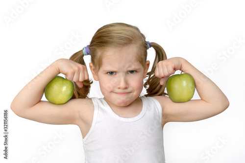 kid child with green apples showing biceps
