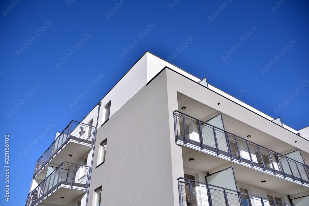 Obraz premium Contemporary residential building exterior in the daylight. Modern and new apartment building. 