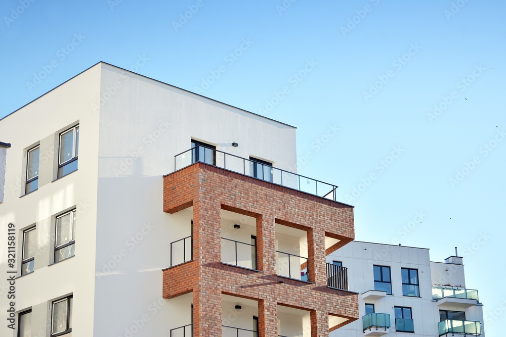 Contemporary residential building exterior in the daylight. Modern and new apartment building. Contemporary residential building exterior in the daylight. Modern and new apartment building.