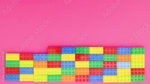 Wallpaper Mural Colorful bricks making wall on pink background - Stop motion Torontodigital.ca