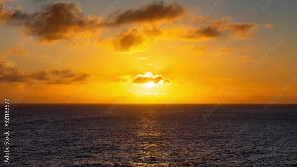 Photo Animation. Dramatic View of a cloudscape during a dark and colorful Orange sunset. Taken in the Tropics of Caribbean Sea in Barbados.
