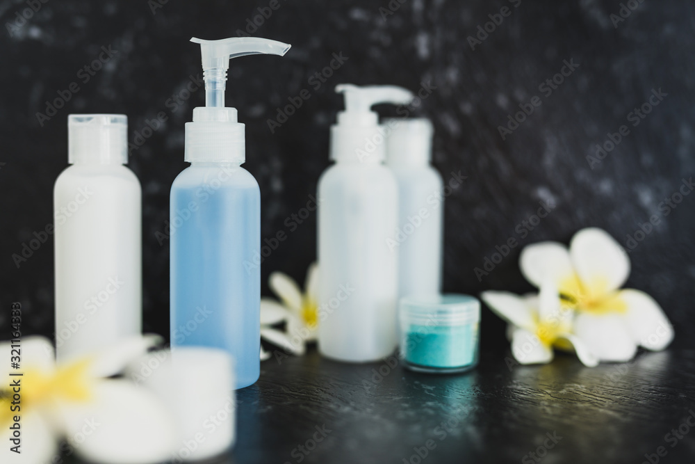lotions and moisturizer bottles on black marble shot at shallow depth of field lotions and moisturizer bottles on black marble shot at shallow depth of field