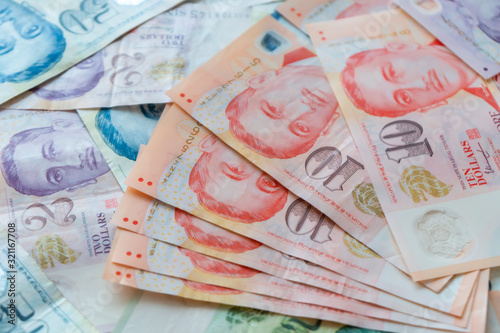Photography Hand holding Singapore Dollar banknote,Background.