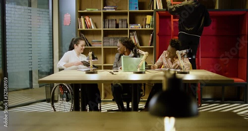 A Team of Young Diverse Entrepreneurs Meeting in Modern Coworking Office Library - Wide Dolly Shot (track right