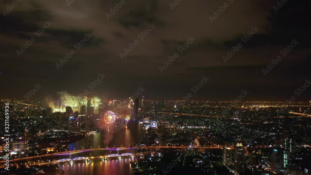 Aerial drone view of fireworks over city skyline on New Year's Eve. City Night Lights Celebration. Aerial drone view of fireworks over city skyline on New Year's Eve. City Night Lights Celebration.