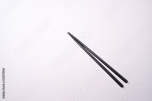 Chopstick on white backdrop and copy space