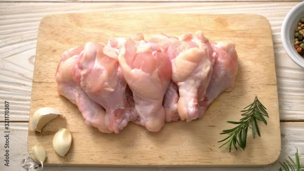 fresh raw chicken wings (drumette or drumstick) on wooden board with ingredients fresh raw chicken wings (drumette or drumstick) on wooden board with ingredients