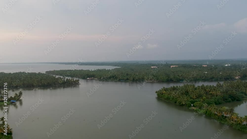 Beautiful aerial shot of Vembanadu Lake,backwater , sunset,coconut trees ,water transportation,clouds,Blue sky,water lines,twilight Beautiful aerial shot of Vembanadu Lake,backwater , sunset,coconut trees ,water transportation,clouds,Blue sky,water lines,twilight
