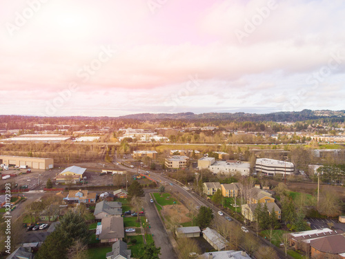 Suburb in the United States, houses in a row and housing estate. Shot from a height at sunset or dawn. © Anton