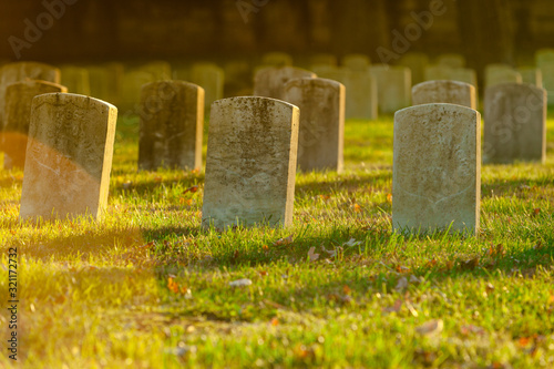 Tombstones in warm Evening Light an Antietam National Cemetery in Sharpsburg, Maryland, USA - with Copy Space photo