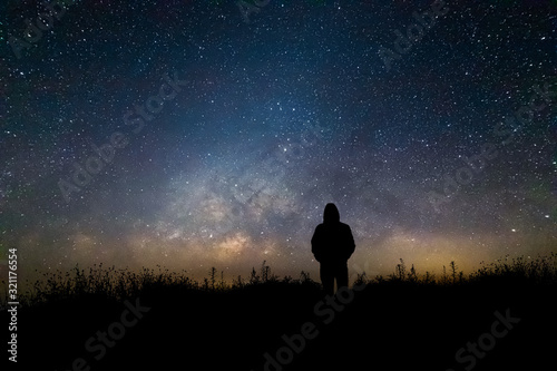 Silhouette man looking milky way in summer night sky