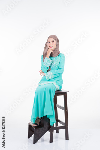 Beautiful female Muslim model in various poses wearing modern kurung and hijab, a modern lifestyle apparel for Muslim women isolated on white. Beauty and hijab fashion concept. Full length portrait