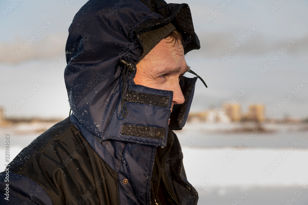 Portrait of a worker in protective workwear with a hood on his head Portrait of a worker in protective workwear with a hood on his head