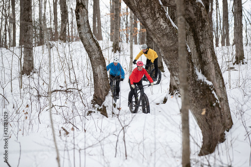 Group of friends riding their fat bike in the snow in Ontario, Canada photo