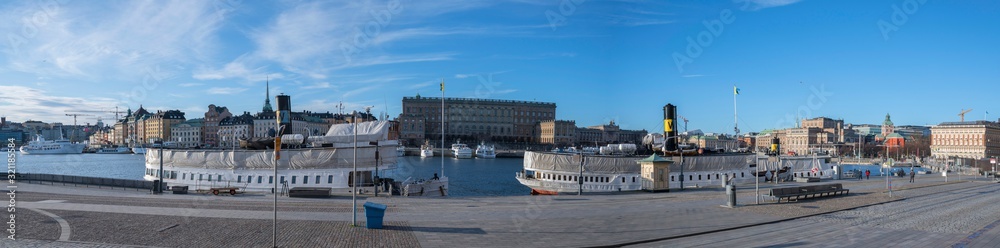 Naklejka premium Winter view over the old town of Stockholm, with churches, castle boats and ferries
