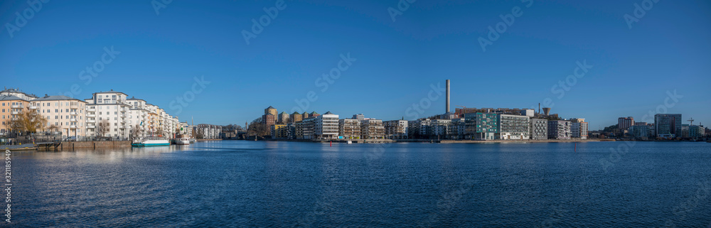 The Lake area Hammarby Sjöstad between the districts Södermalm, Hammarby and Sickla in Nacka. Stockholm a sunny winter day. Boats, piers and houses surrounding the lake area. 