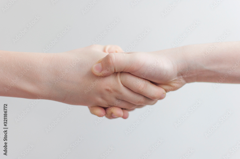 Two friends are holding hands together. Two friends are holding hands together.