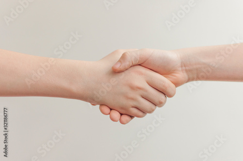 Two friends are holding hands together.