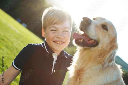 A child with a dog in nature. 
