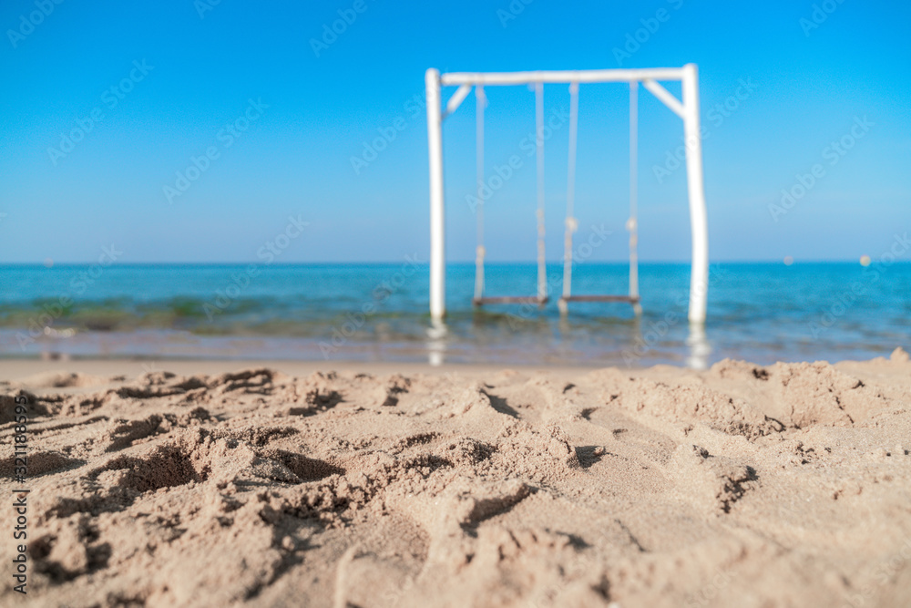 Empty swing on tropical beach with blue sky Empty swing on tropical beach with blue sky