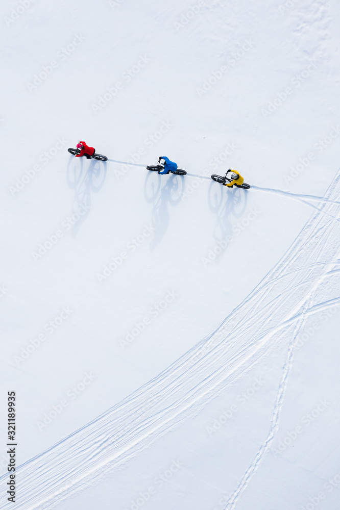 Aerial drone photo of a group of friends riding their fat bike in the snow in Ontario, Canada