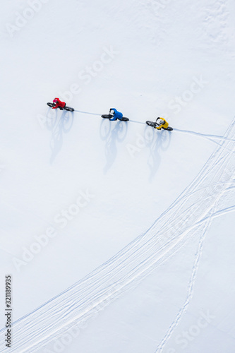 Obraz na płótnie Aerial drone photo of a group of friends riding their fat bike in the snow in Ontario, Canada w salonie