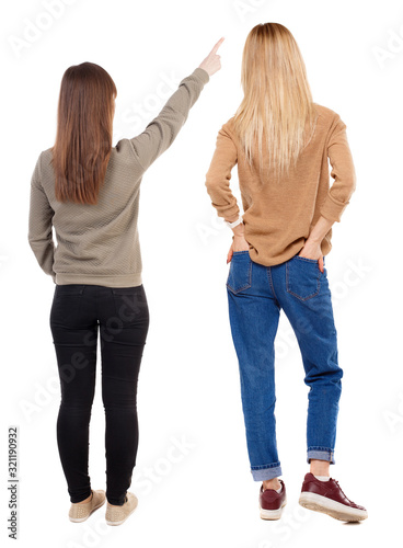 Back view of two pointing young girl in sweater.