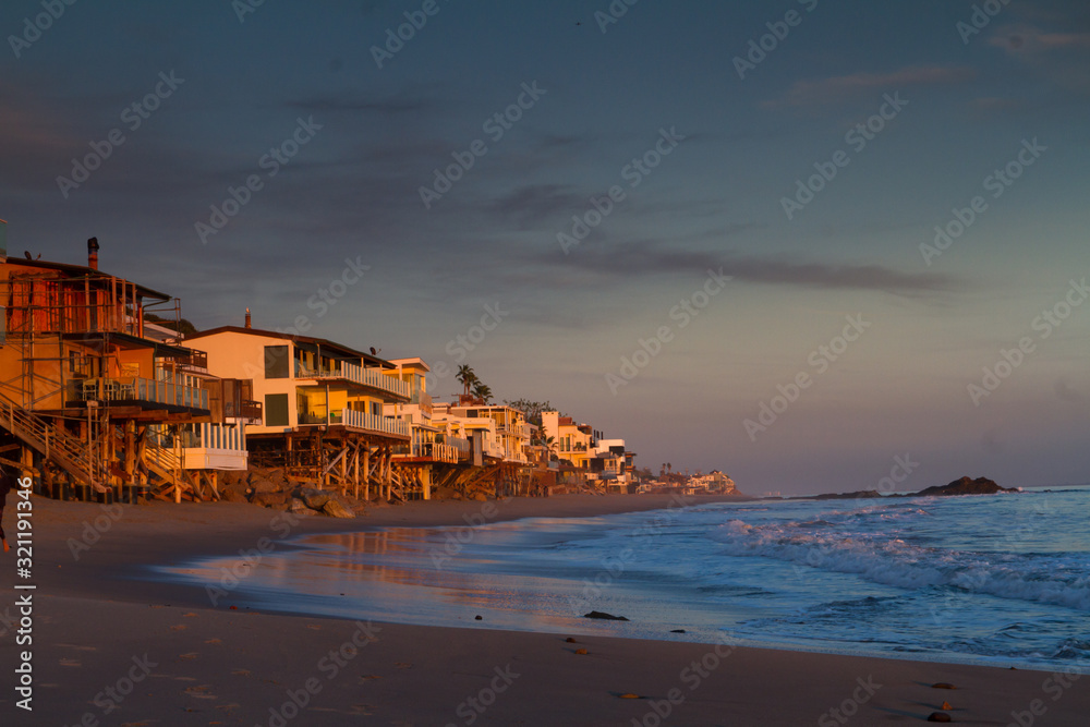 Oceanfront homes on Malibu Beach at sunset