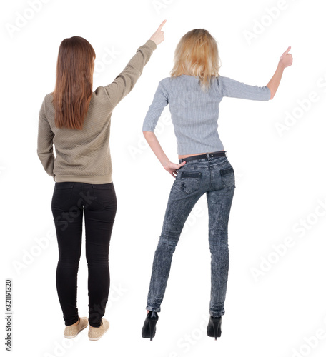 Back view of two pointing young girl in sweater.