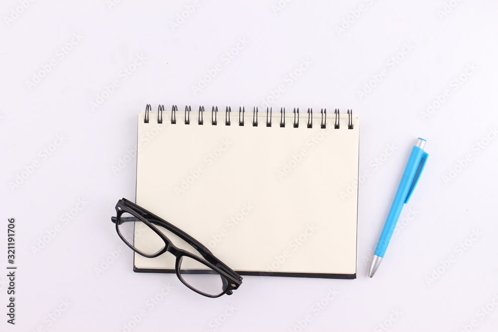 Top view blank notebook with pen on white background