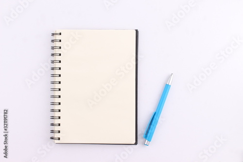 Top view blank notebook with pen on white background
