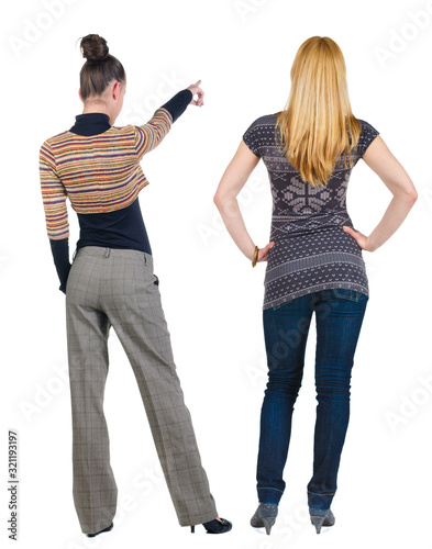 Back view of two pointing young girl in sweater.