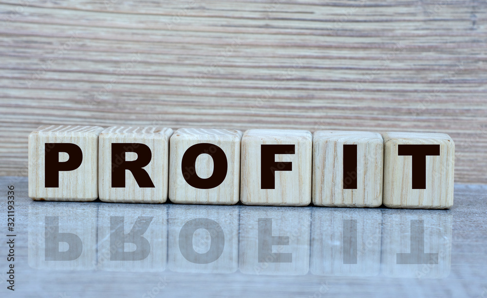 Fototapeta premium concept word profit on cubes with a mirror image on a grey shiny background