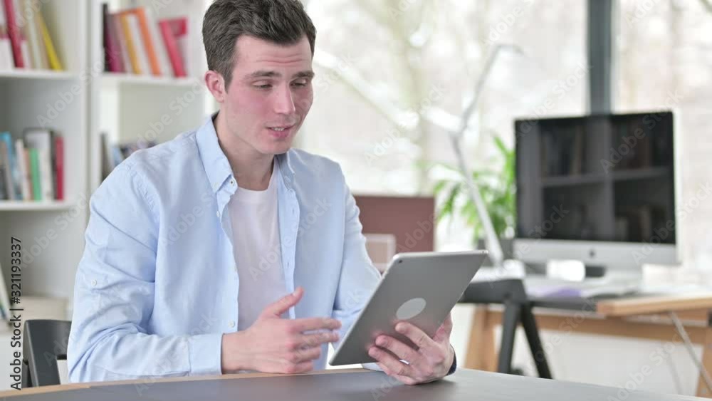 Online Video Chat on Tablet by Young Man Online Video Chat on Tablet by Young Man