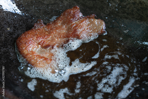 Fired pork in a pan hot oil