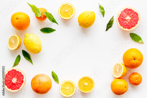 Citrus fruits - lemons, grapefruits - on white background mockup, frame top-down copy space