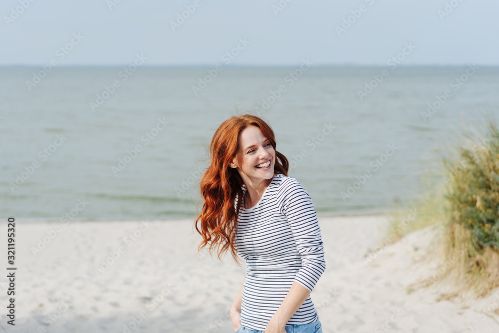 Smiling happy young woman enjoying the coast Smiling happy young woman enjoying the coast