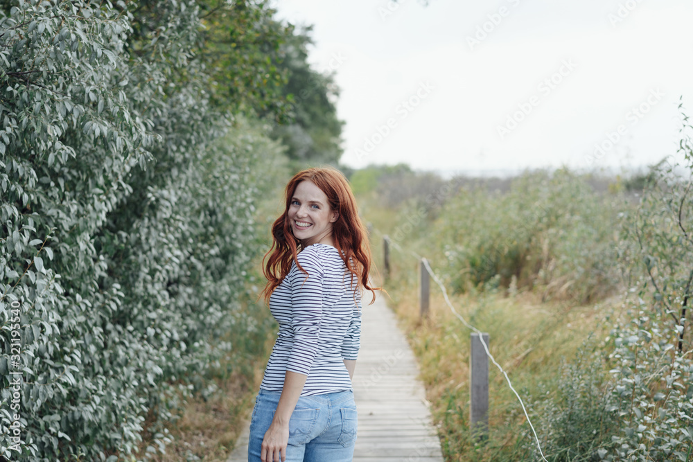 Pretty young redhead woman turning to the camera Pretty young redhead woman turning to the camera