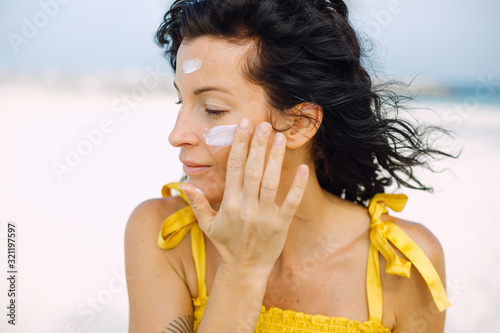 Woman with a suncream on her face