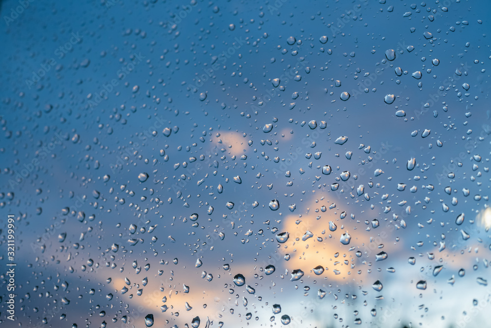 Drops on the glass against a beautiful blue-purple sky with clouds Drops on the glass against a beautiful blue-purple sky with clouds