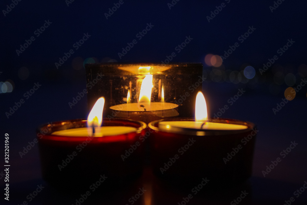 Three lit candles create a romantic atmosphere