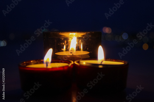 Three lit candles create a romantic atmosphere