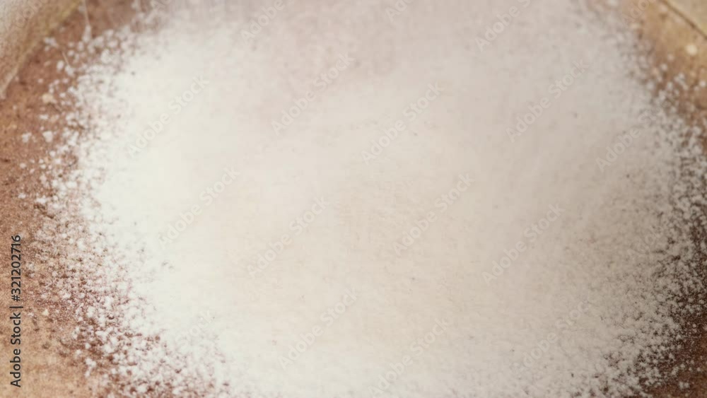Falling cocoa and flour. Sifting ingredients for the preparation of the dough. Macro. Top view. Slow motion. Food concept. Falling cocoa and flour. Sifting ingredients for the preparation of the dough. Macro. Top view. Slow motion. Food concept.
