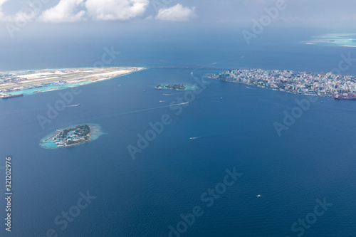 Male island, capital of Maldives with boats and ships. Amazing aerial landscape, exotic travel destination