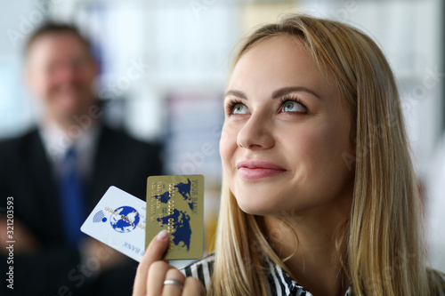 Manager restores solvency company or enterprise. Specialist is proud her achievements, girl is holding golden bank cards in her hands. Assistance to top managers business management enterprises. photo